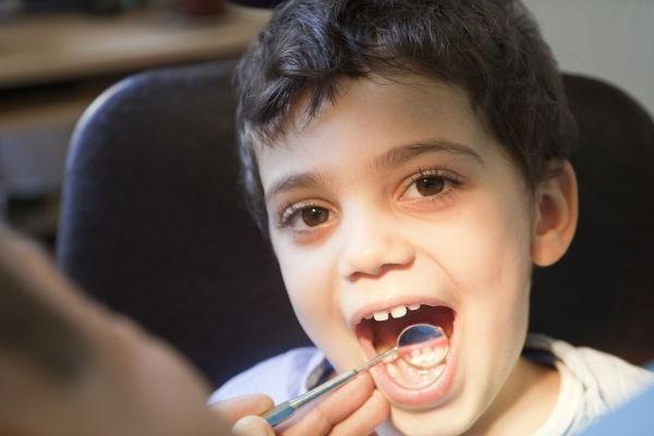 cute kid pointing to tooth